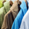 bathrobes of different colors hang on a hanger